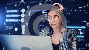 Smart young woman programmer working with computer in modern office of digital company, portrait