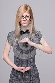 Smart young woman rounding circular empty space by hands concept