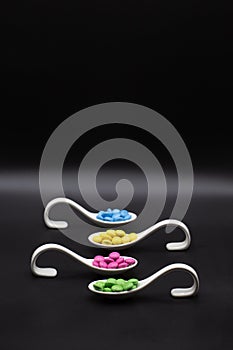smarties in different colors on try plates for buffet sorores or party with black background