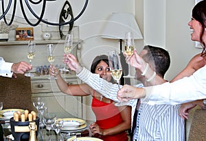 Smartly dressed people at a dinner party with Champagne