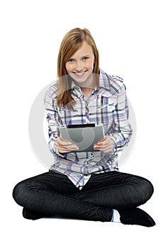 Smartly dressed teenager surfing on tablet pc