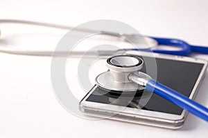 Smartphone being diagnosed by stethoscope - phone repair and check up concept