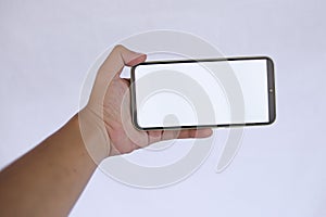 Hand Holding Smartphone with Blank White Screen on light Background