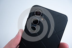 Smartphone in Black Leather Case in Hand