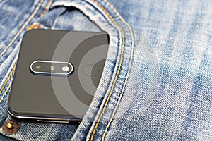 Smartphone in the blue jean pocket