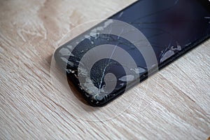 Smartphone with broken touchscreen screen on table desktop