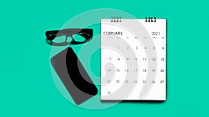 Smartphone,calender and glasses on green background top view mockup screen.