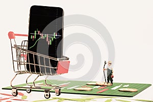 Smartphone with Candlestick chart on screen in red cart