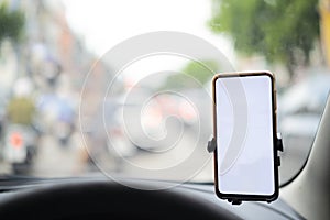 Smartphone in a car use for Navigate or GPS. Driving a car with Smartphone in holder.