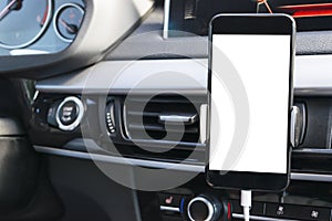 Smartphone in a car use for Navigate or GPS. Driving a car with Smartphone in holder. Mobile phone with isolated white screen.