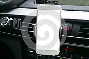 Smartphone in a car use for Navigate or GPS. Driving a car with Smartphone in holder. Mobile phone with isolated white screen.