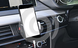 Smartphone in a car use for Navigate or GPS. Driving a car with Smartphone in holder. Mobile phone with isolated white screen.