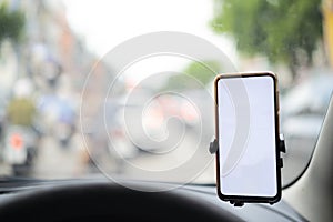 Smartphone in a car use for Navigate or GPS. Driving a car with Smartphone in holder. Mobile phone isolated white screen.