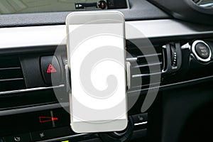 Smartphone in a car use for Navigate or GPS. Driving a car with Smartphone in holder. Mobile phone with white screen.