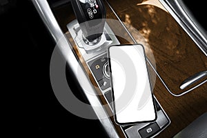 Smartphone in a car use for navigate or GPS. Driving a car with smartphone. Mobile phone with isolated white screen. Blank empty