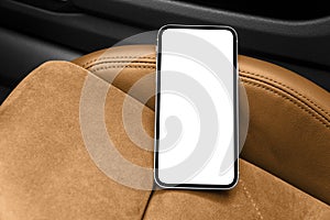 Smartphone in a car use for navigate or GPS. Driving a car with smartphone. Mobile phone with isolated white screen on brown