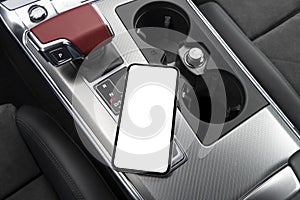 Smartphone in a car use for navigate or GPS. Driving a car with smartphone. Mobile phone with isolated white screen on car