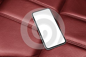 Smartphone in a car use for navigate or GPS. Driving a car with smartphone. Mobile phone with isolated white screen on red