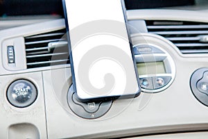 Smartphone in a car use for Navigate or GPS. Driving a car with Smartphone in holder. Mobile phone white screen. Blank