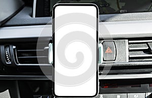 Smartphone in a car use for Navigate or GPS. Driving a car with Smartphone in holder. Mobile phone with  white screen. Bla