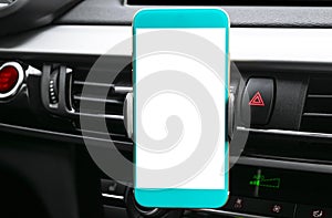 Smartphone in a car use for Navigate or GPS. Driving a car with Smartphone in holder. Mobile phone with isolated white screen. Bla