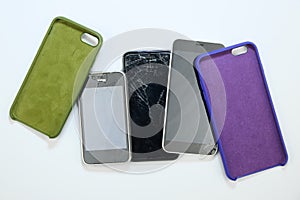 smartphone cases and three broken smartphones