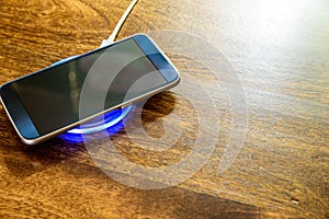 Smartphone charging on a charging pad. Wireless charging