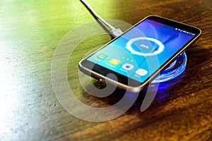 Smartphone charging on a charging pad. Wireless charging