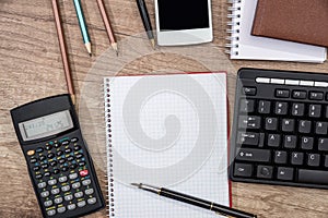 Smartphone, computer keyboard, calculator, pen and notepad on the office table. Copy space for text