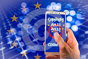 Smartphone with Copyright and EU flag on screen. CDSM metaphor