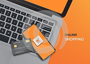 Smartphone and credit card on computer laptop for online shopping concept