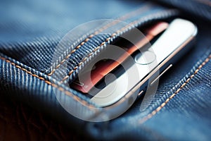 Smartphone in denim pocket close-up