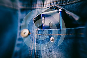 Smartphone with dual camera lens on the jeans pocket