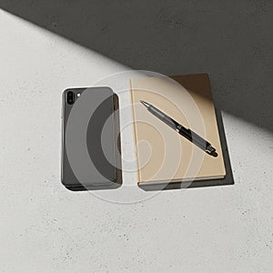 A smartphone with a dual-camera setup, a beige notebook, and a black pen are