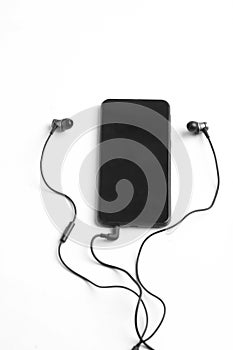 Smartphone and earphone or headphone on white background