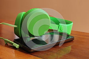 Smartphone and green headphone
