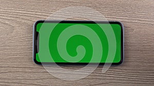 Smartphone with green screen mockup, swipe hand close up, mobile phone user