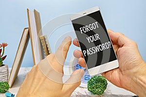 Smartphone in hand with the inscription Forgot your password