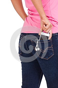 Smartphone with Headphones in pocket of girl's jeans.