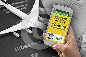 Smartphone with international certificate of vaccination against covid-19 with passport background