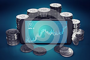 Smartphone with IOTA growth chart on-screen among piles of IOTA coins photo
