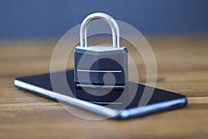 Smartphone with lock on screen is on table