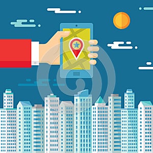 Smartphone with map & location in human hand on the background of the city for presentation and different design works.