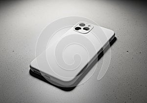 A smartphone with a minimalist white case lies on a speckled