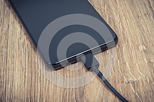 Smartphone, mobile phone and connected cable of charger. Telephone charging