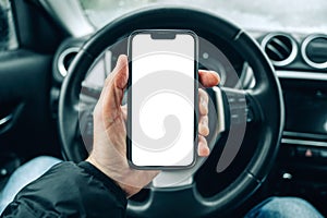 Smartphone mockup screen, male driver using mobile phone in car on cold winter day