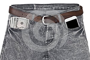 Smartphone and money in pocket jeans.