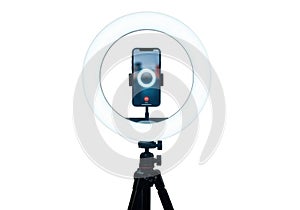 Smartphone mounted in a ring light on a tripod isolated on white background