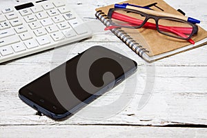 Smartphone with notebook and cupon wooden table photo