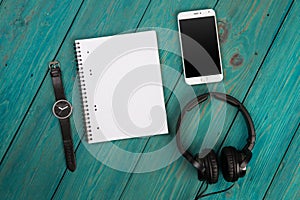 Smartphone, notepad, headphones and watch